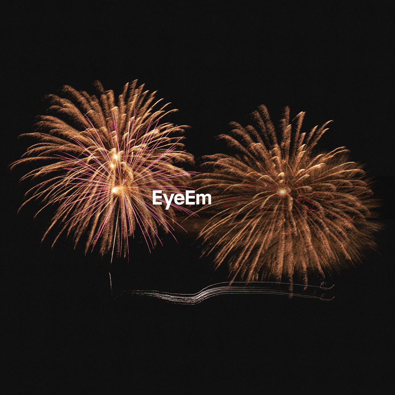 Low angle view of firework display at night