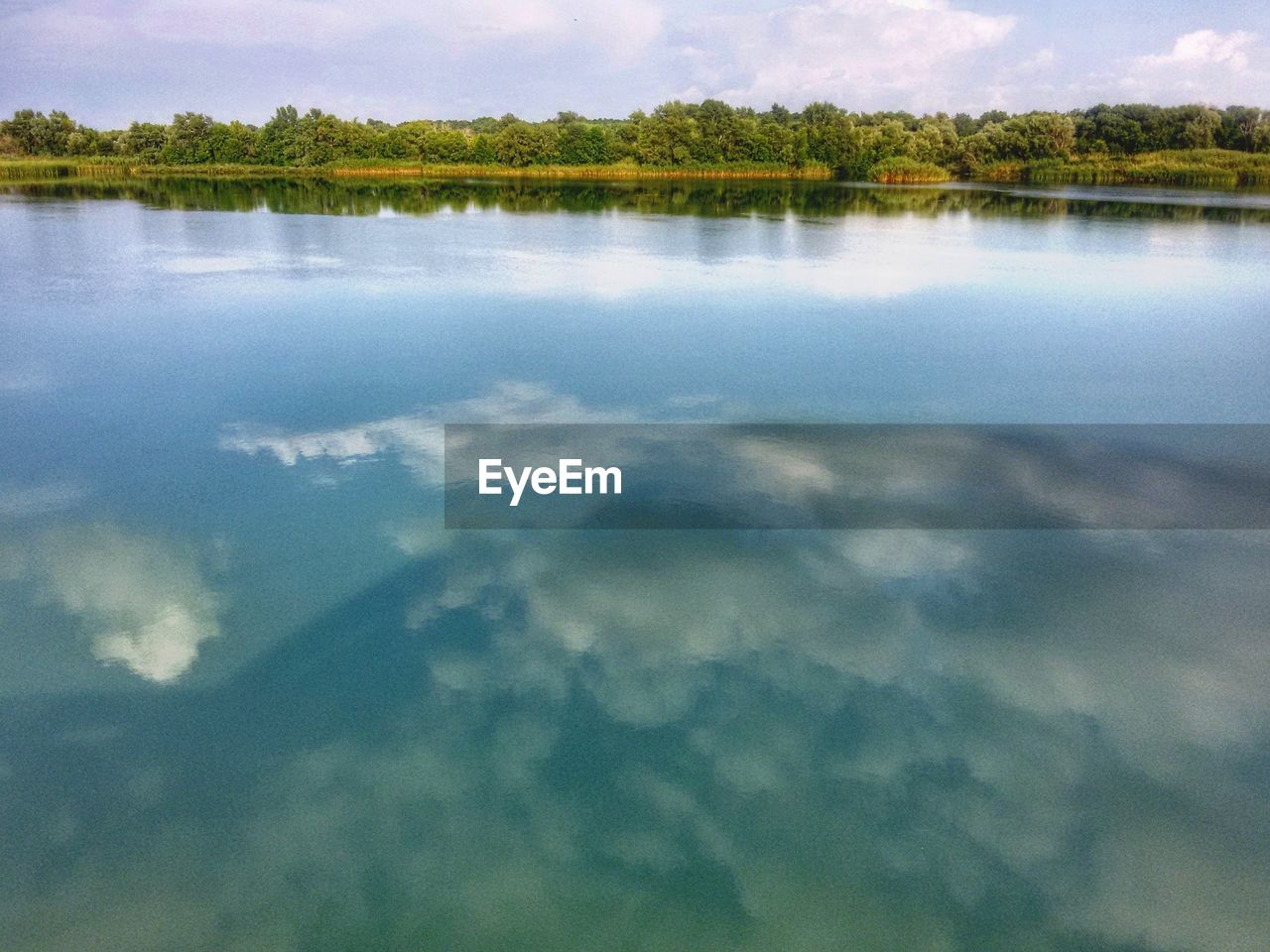 REFLECTION OF SKY IN LAKE