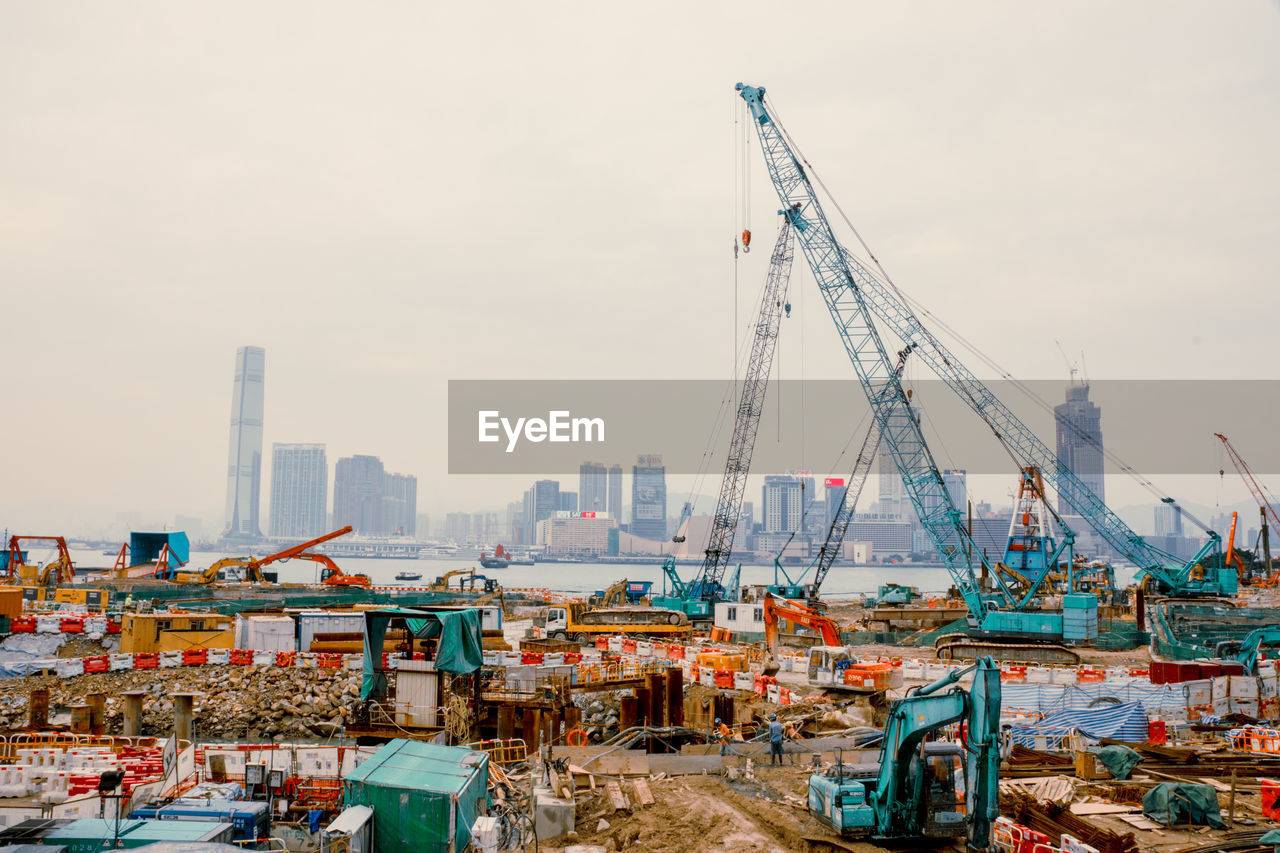 Cranes and machinery at victoria harbour in city