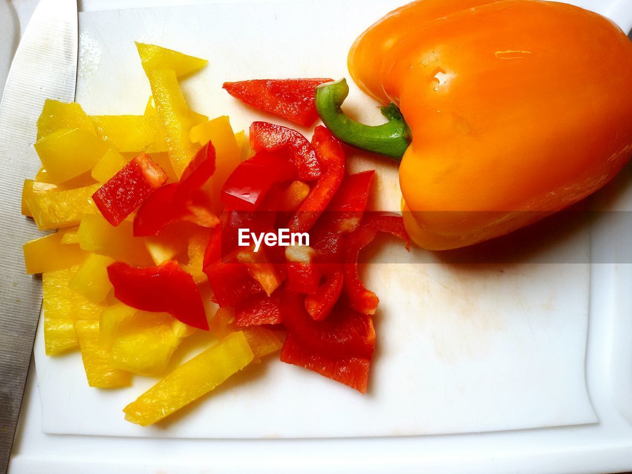 Close-up cutting peppers on cutting board