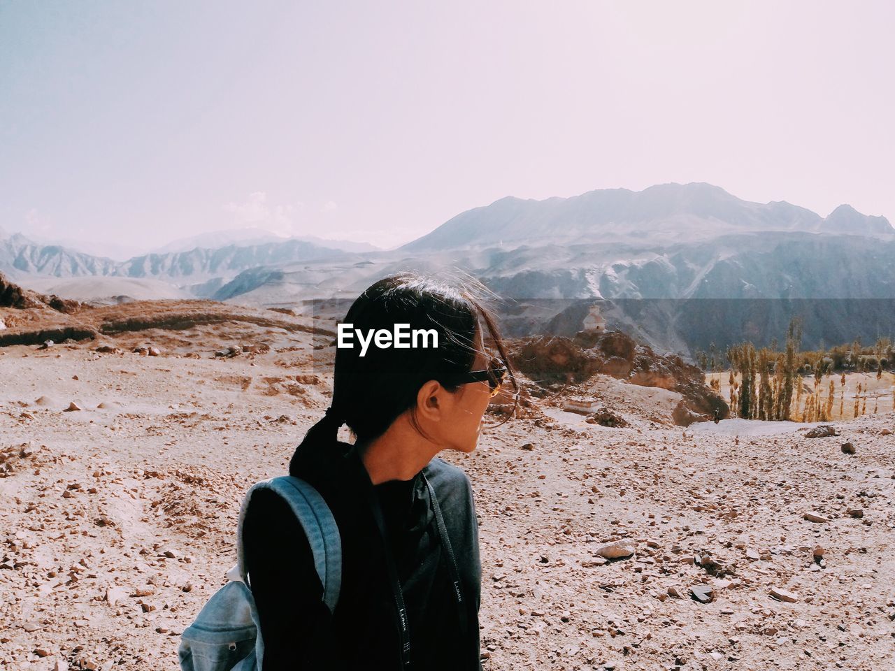 Close-up of woman on mountain against sky