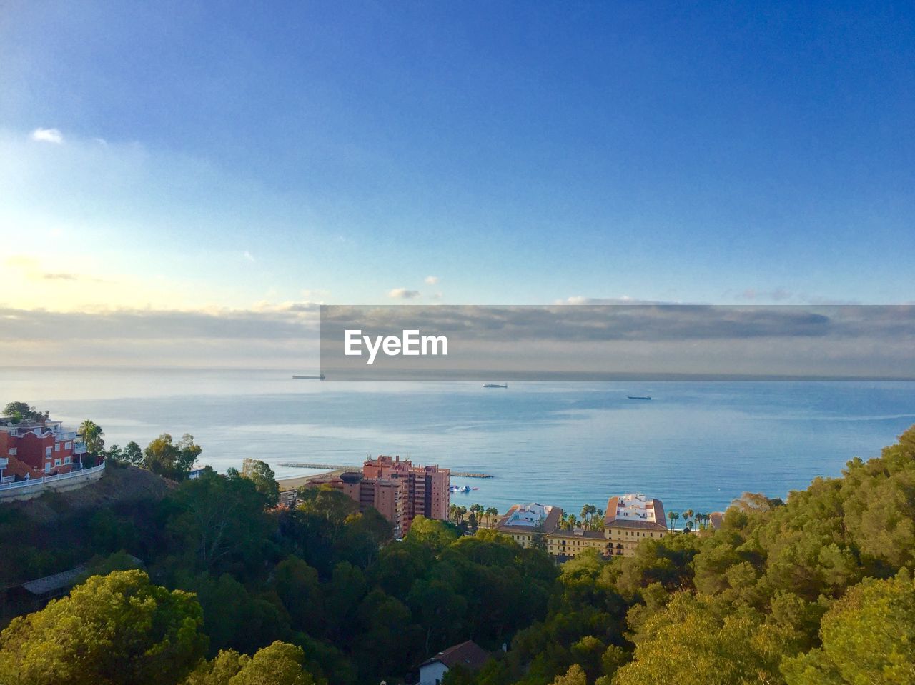 SCENIC VIEW OF SEA AGAINST BUILDINGS IN CITY