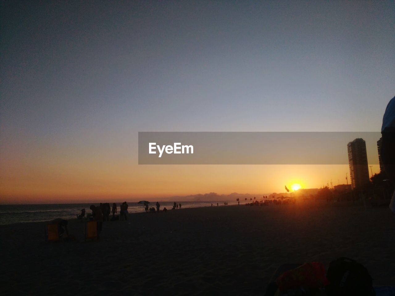 SILHOUETTE BEACH AGAINST CLEAR SKY DURING SUNSET