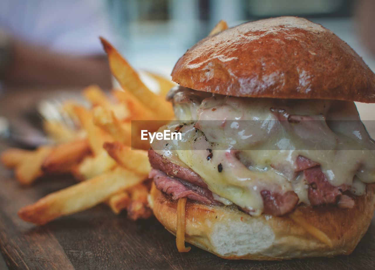 Close-up of burger with french fries on table