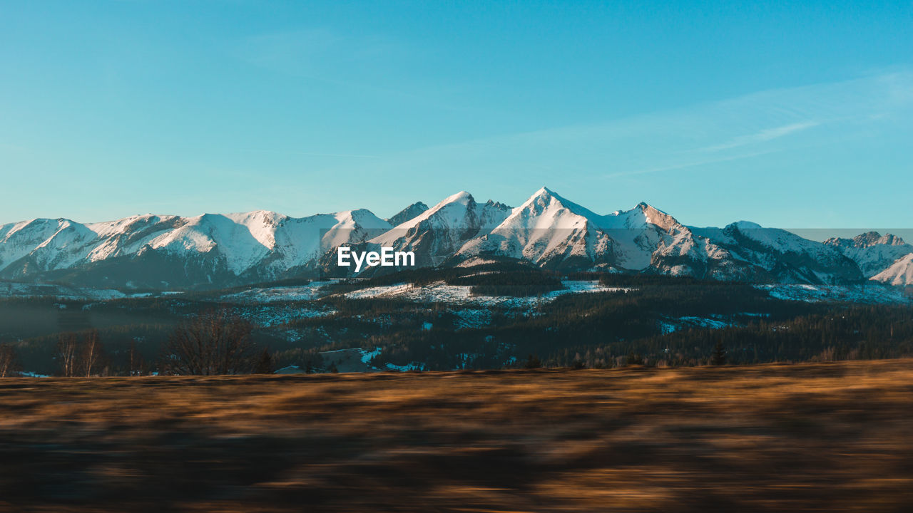 Scenic view of snowcapped mountains against sky