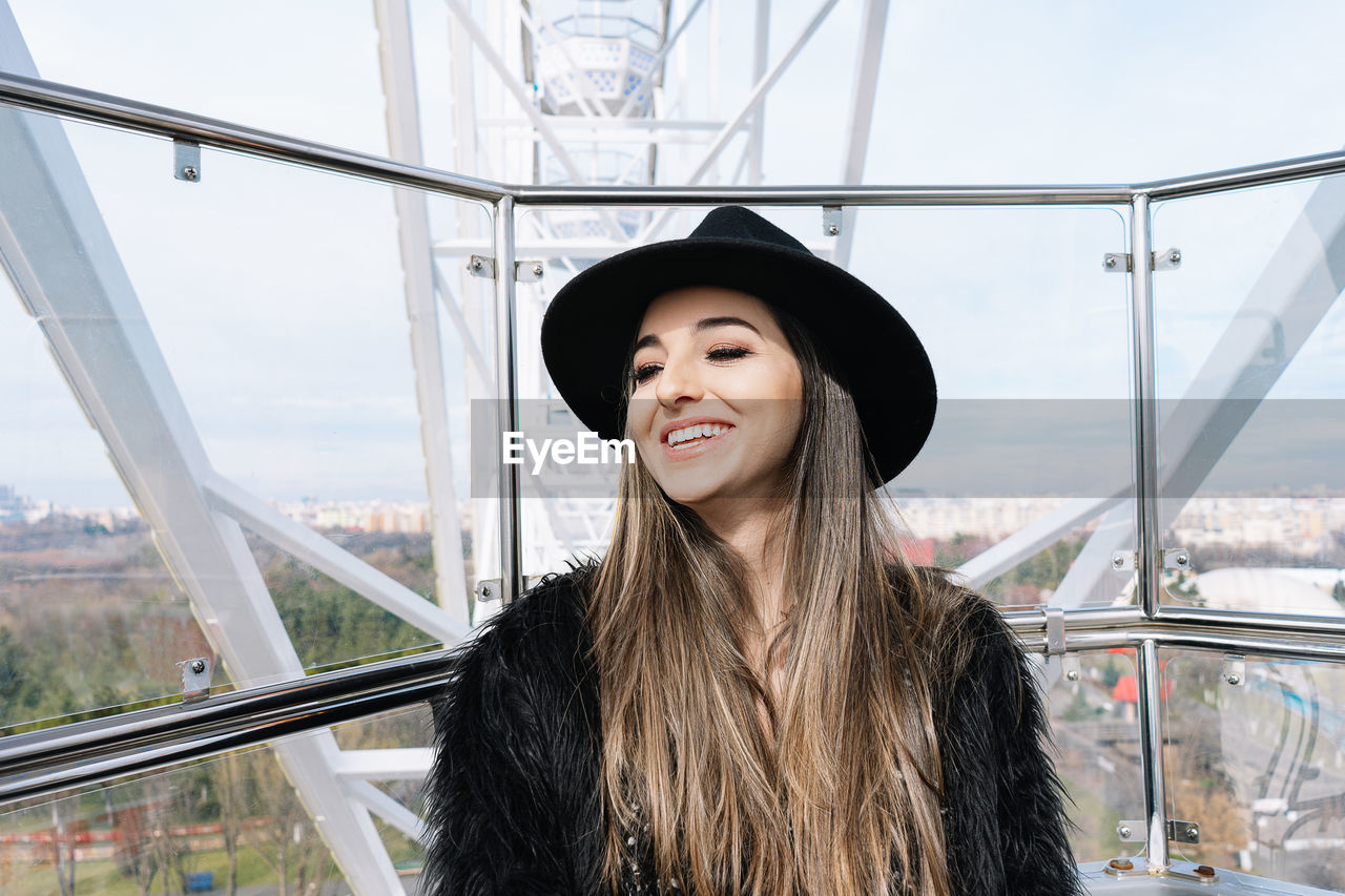 Portrait of smiling young woman in ferris wheel