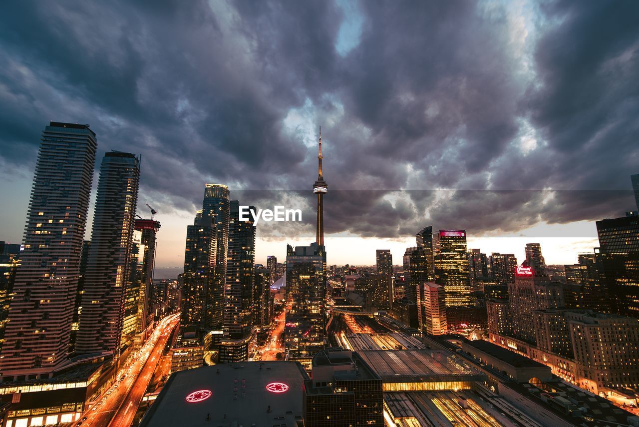 View of skyscrapers in city against cloudy sky