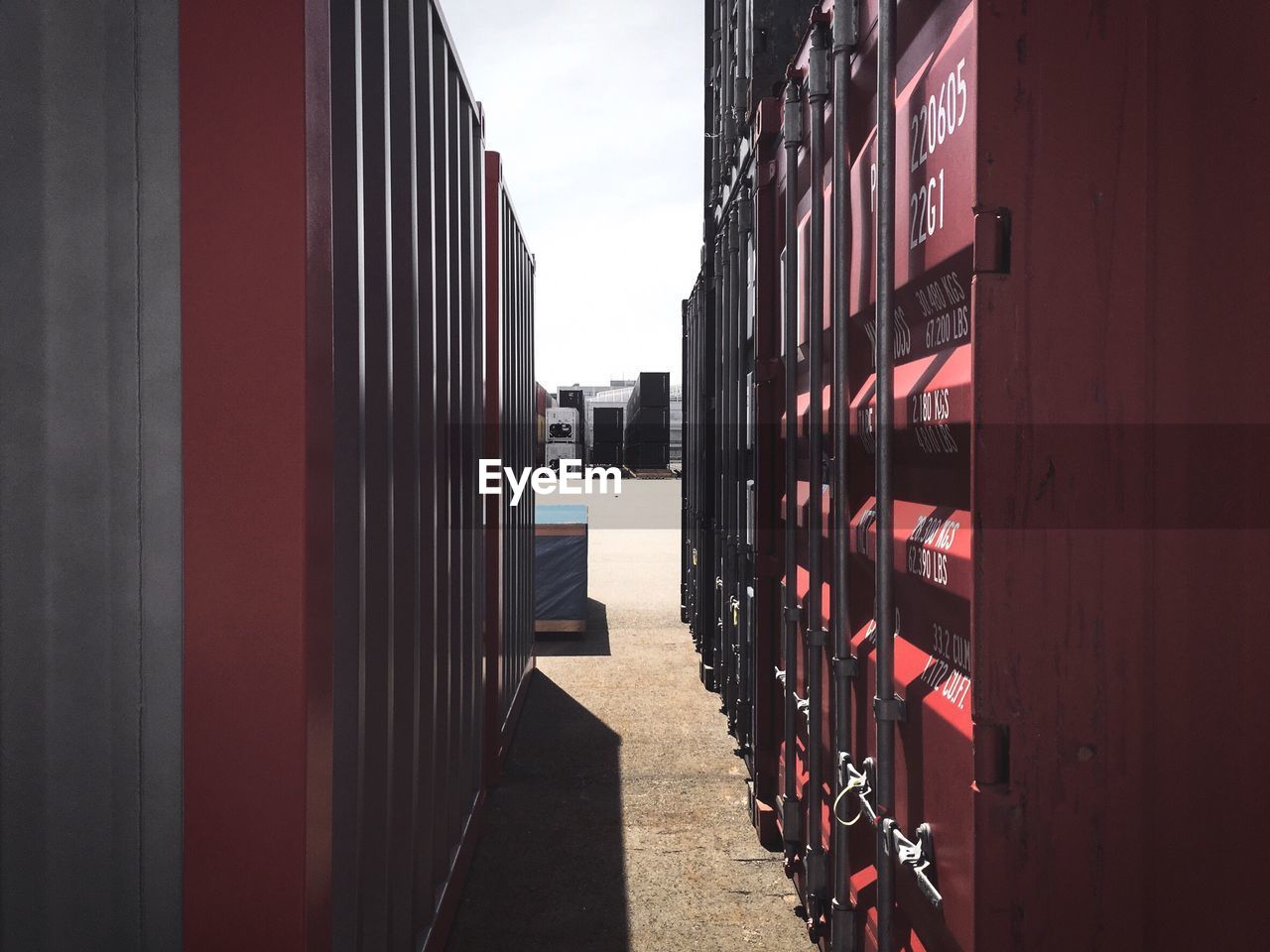 Cargo containers at dock against clear sky