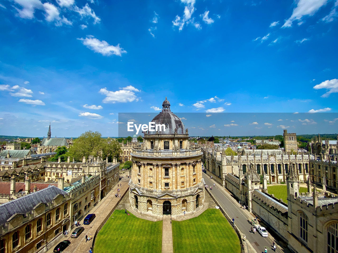 Aerial view of buildings in city against sky