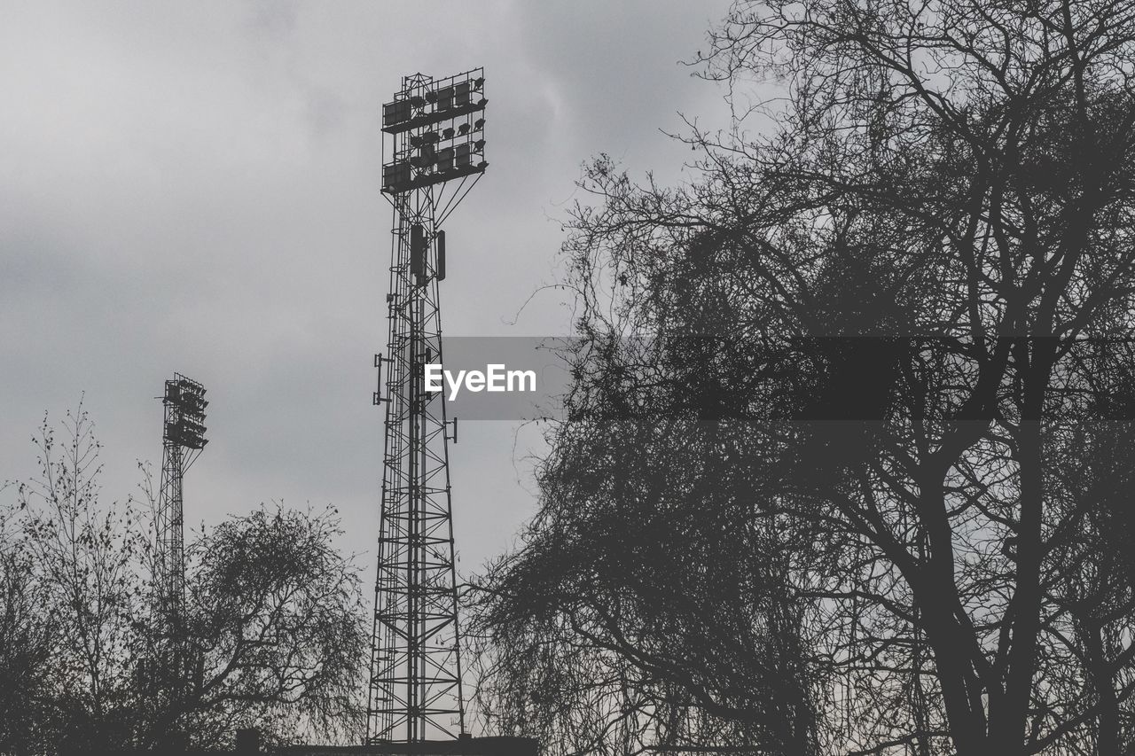 LOW ANGLE VIEW OF TREES AND TOWER AGAINST SKY