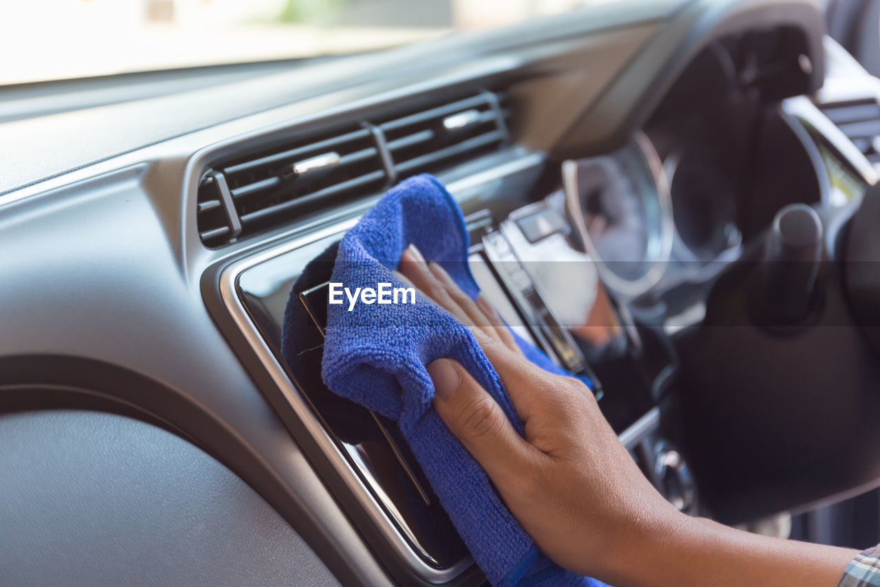 Cropped image of hand cleaning car