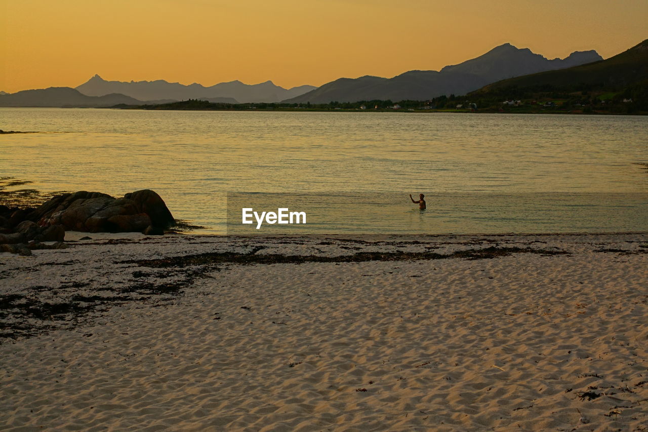 VIEW OF BEACH AT SUNSET