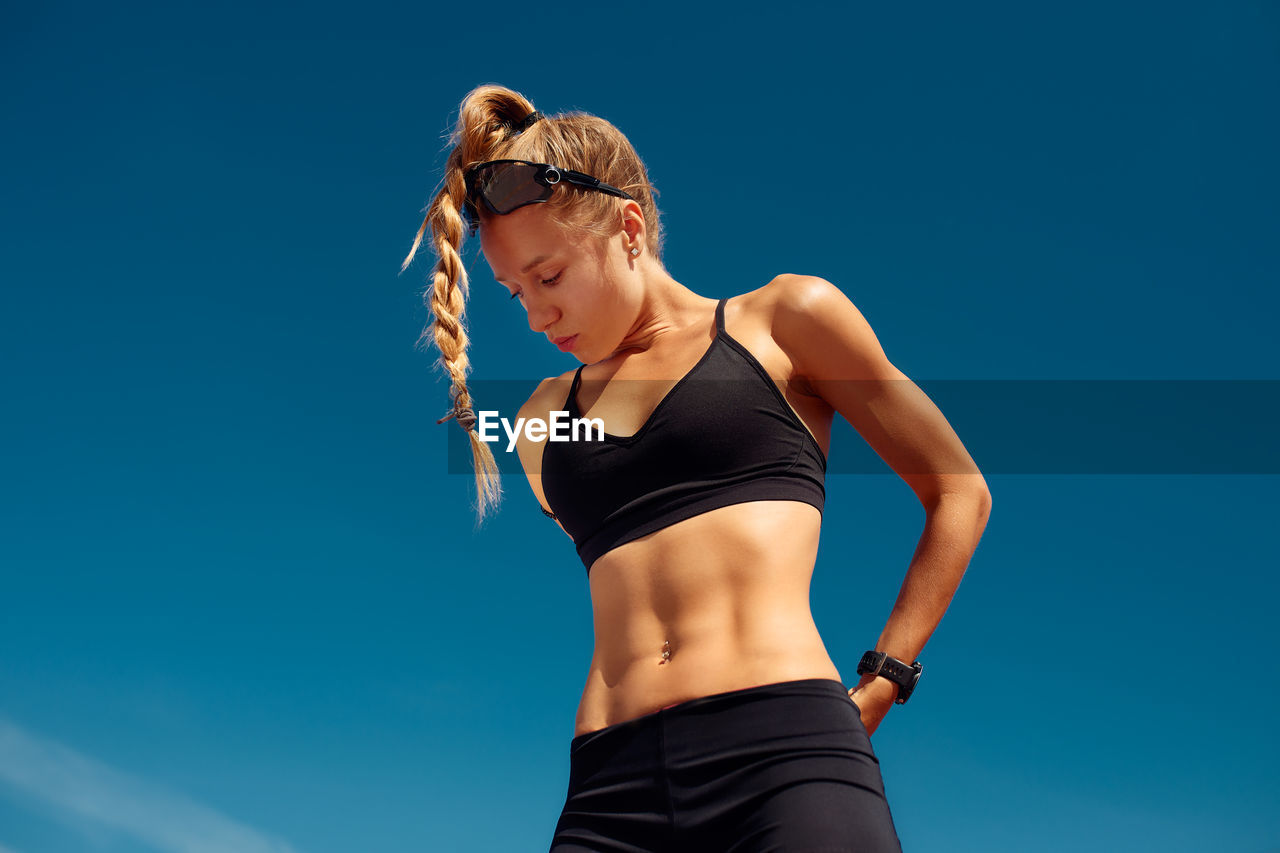 low angle view of woman standing against clear sky