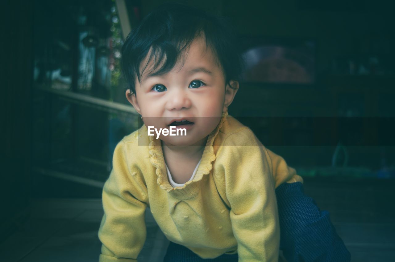 Portrait of cute girl standing at home