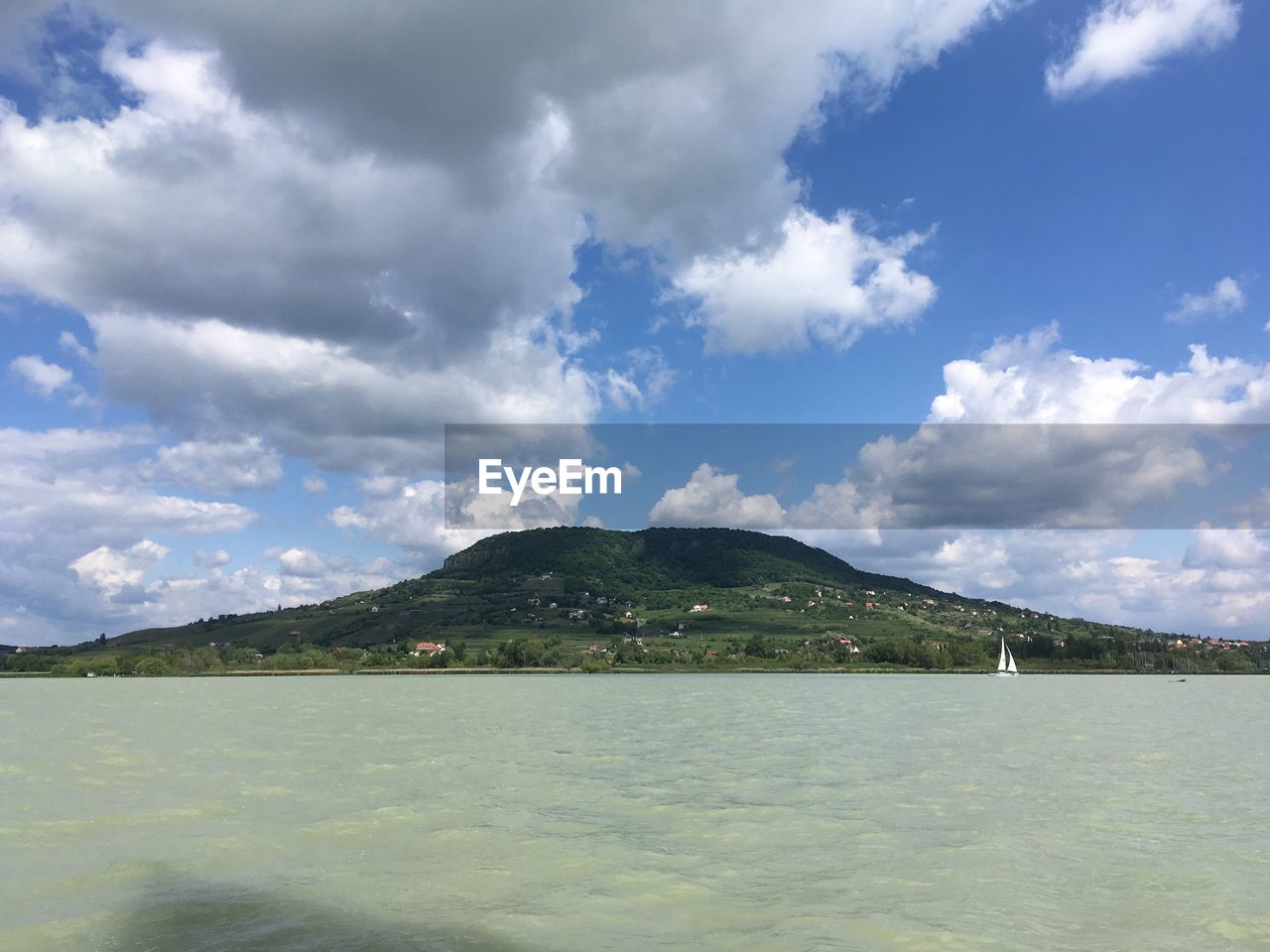 SCENIC VIEW OF SEA WITH MOUNTAINS IN BACKGROUND