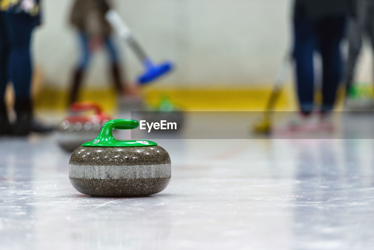 Low section of people playing curling on ice rink