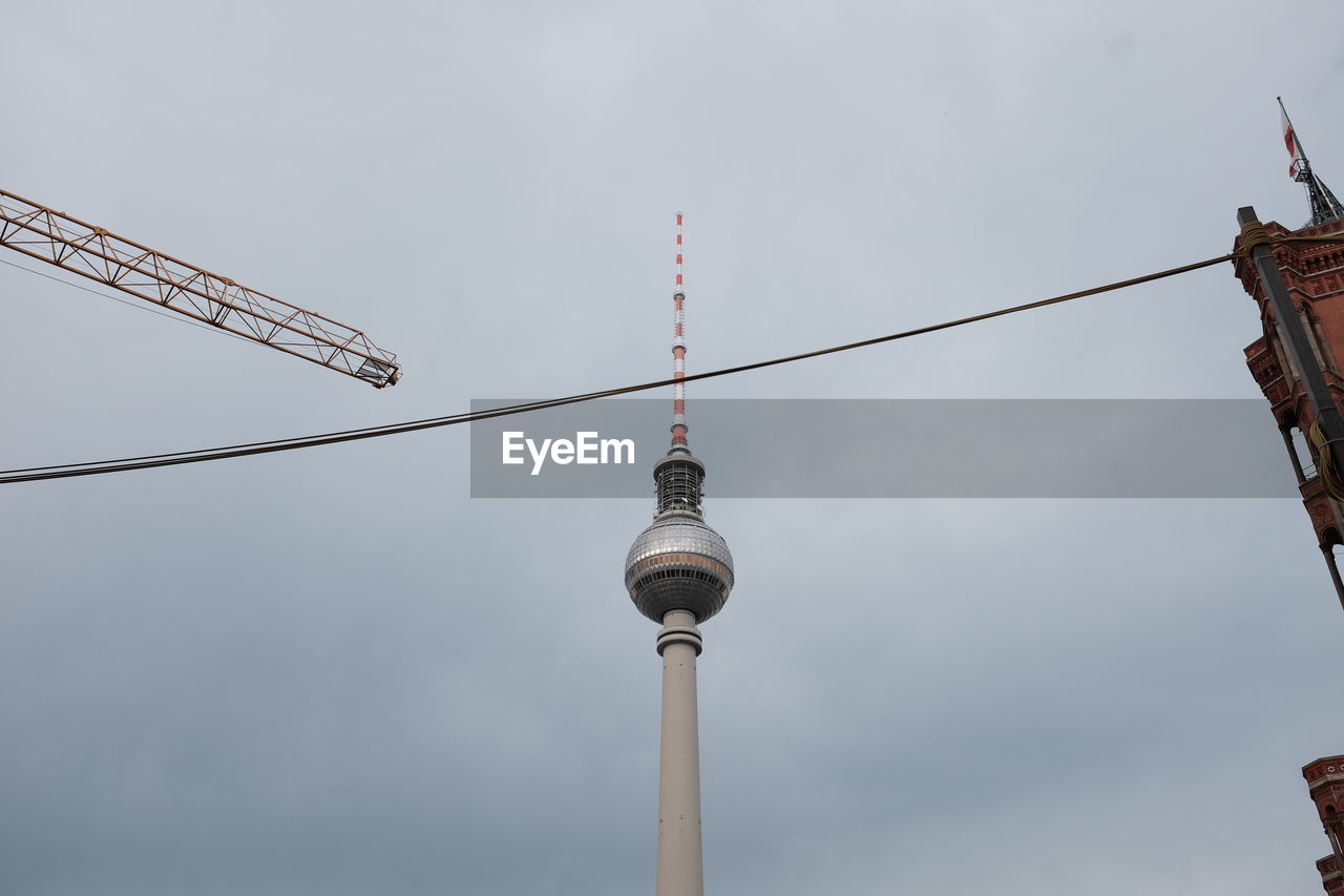 Low angle view of fernsehturm against sky in city