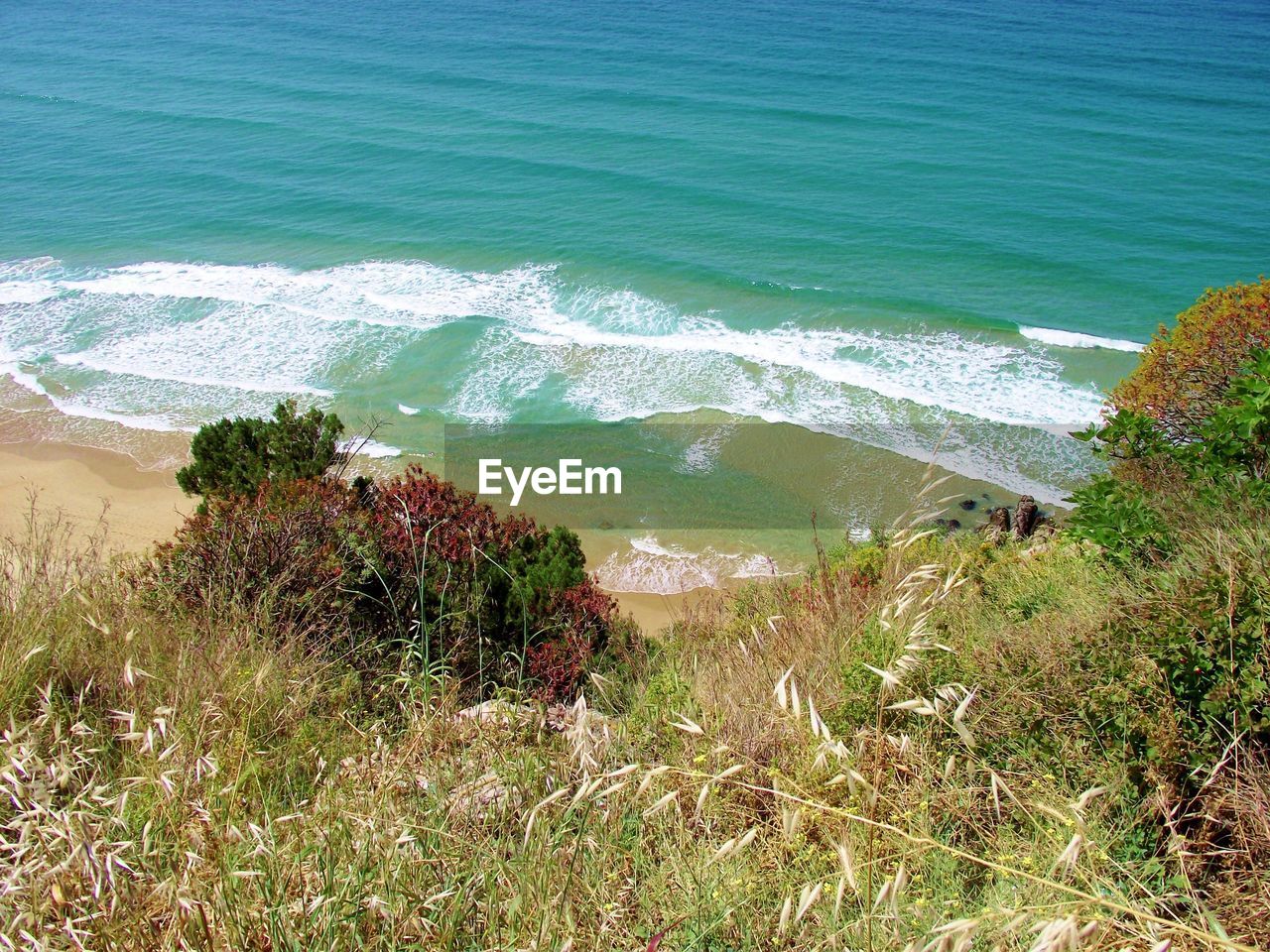 SCENIC VIEW OF SEA WITH MOUNTAIN IN BACKGROUND