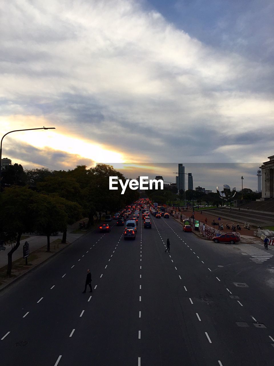 High angle view of vehicles on road against cloudy sky during sunset