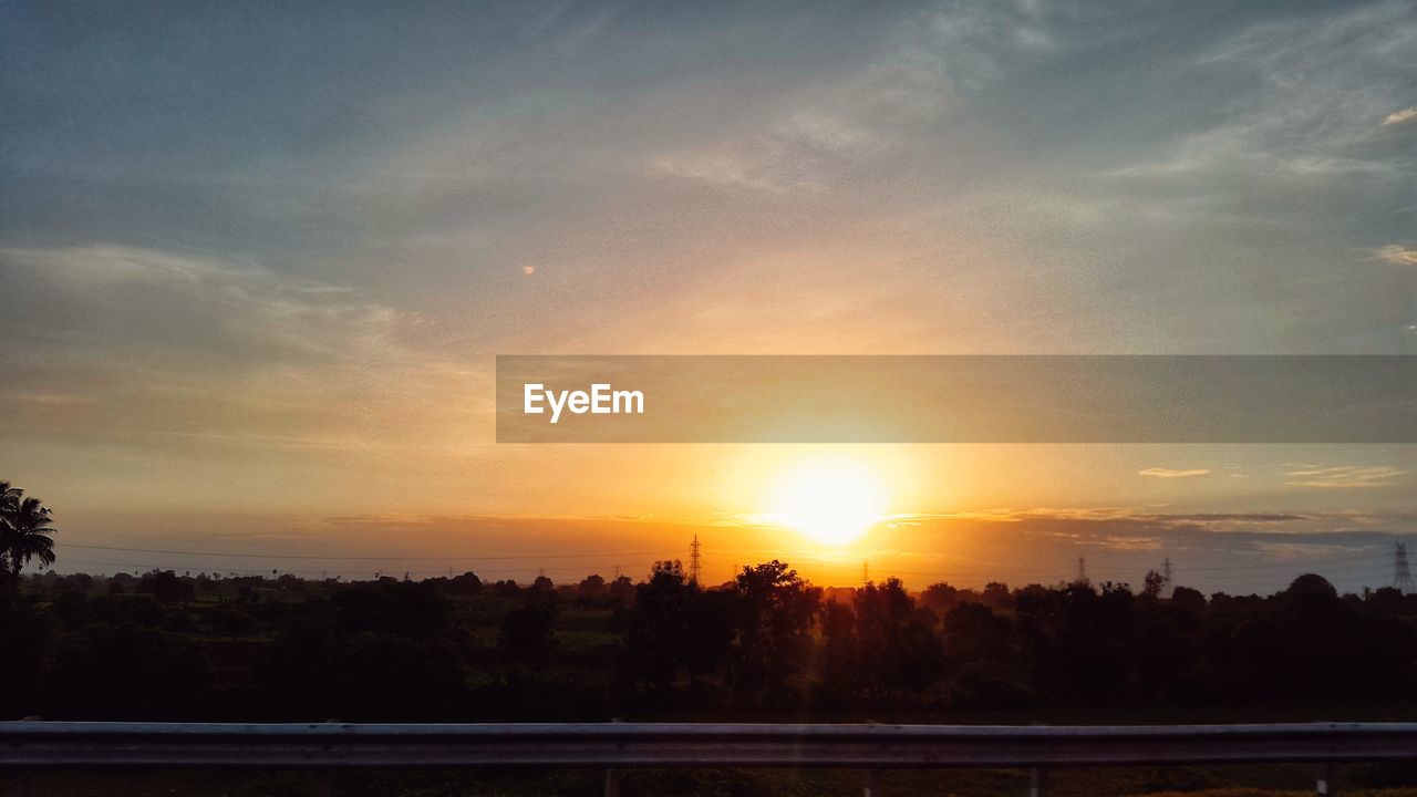 SCENIC VIEW OF SUNSET OVER SILHOUETTE LANDSCAPE