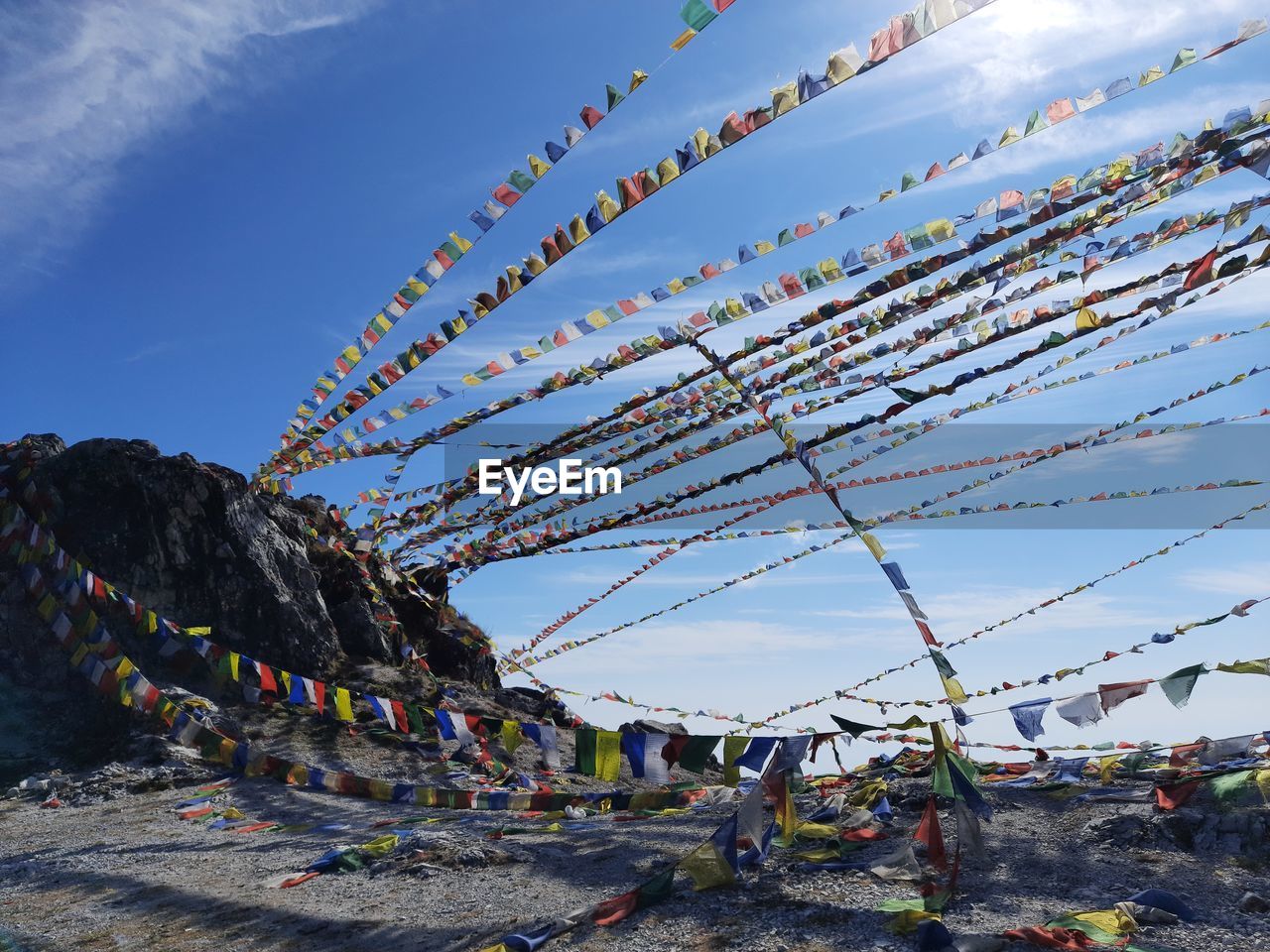 Low angle view of multi colored prayer flags against sky