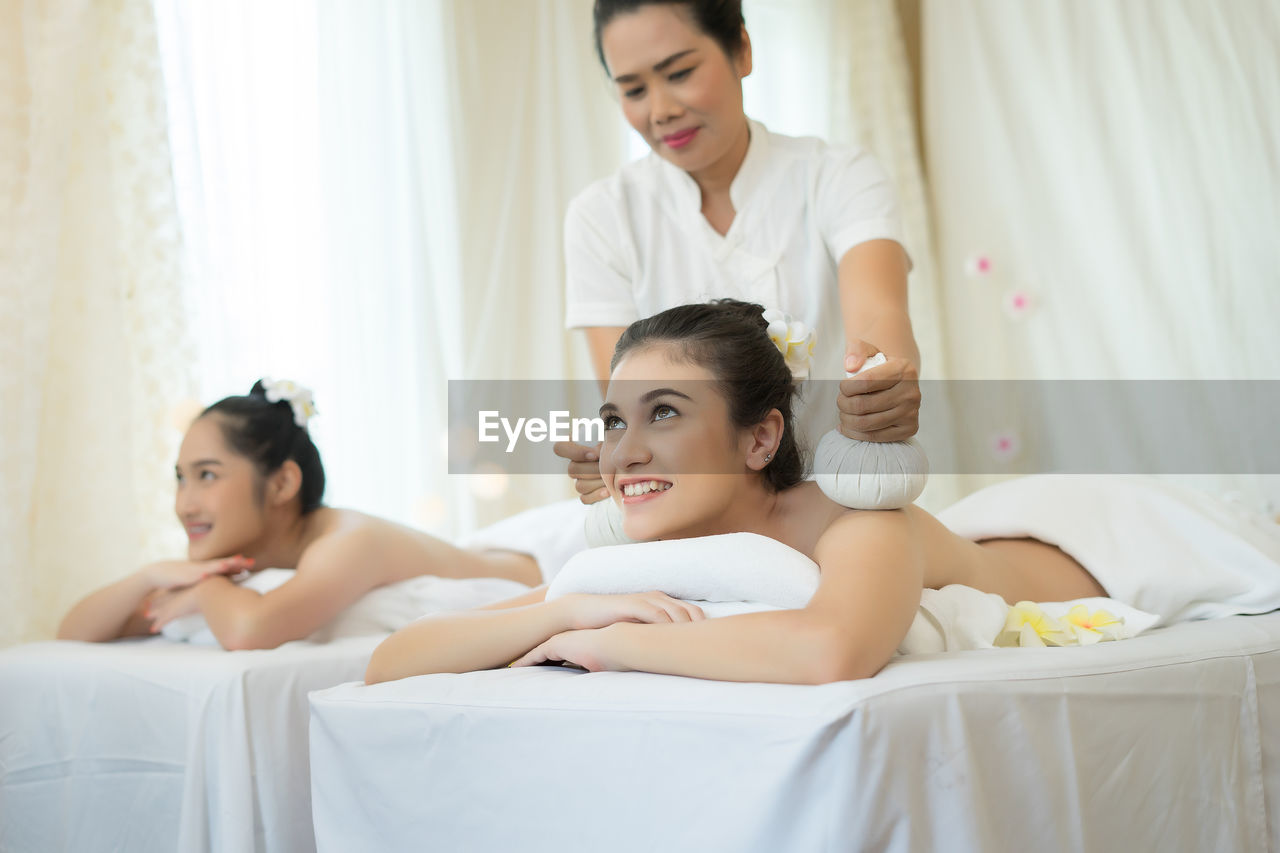 Young woman receiving massage in spa