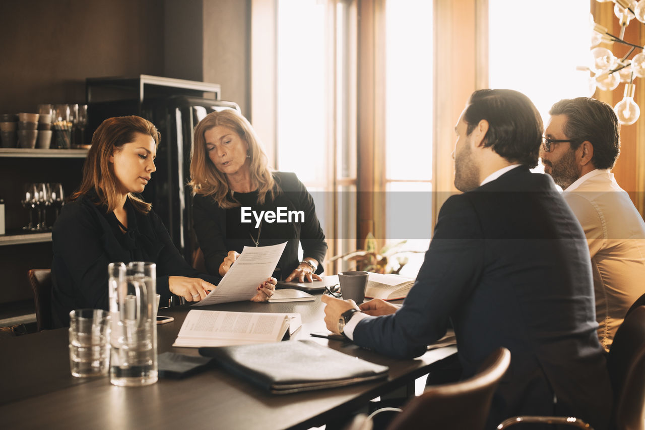 Lawyers discussing over evidence in meeting at office