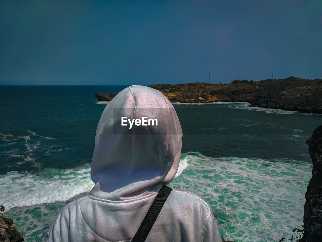 Rear view of woman looking at sea against sky