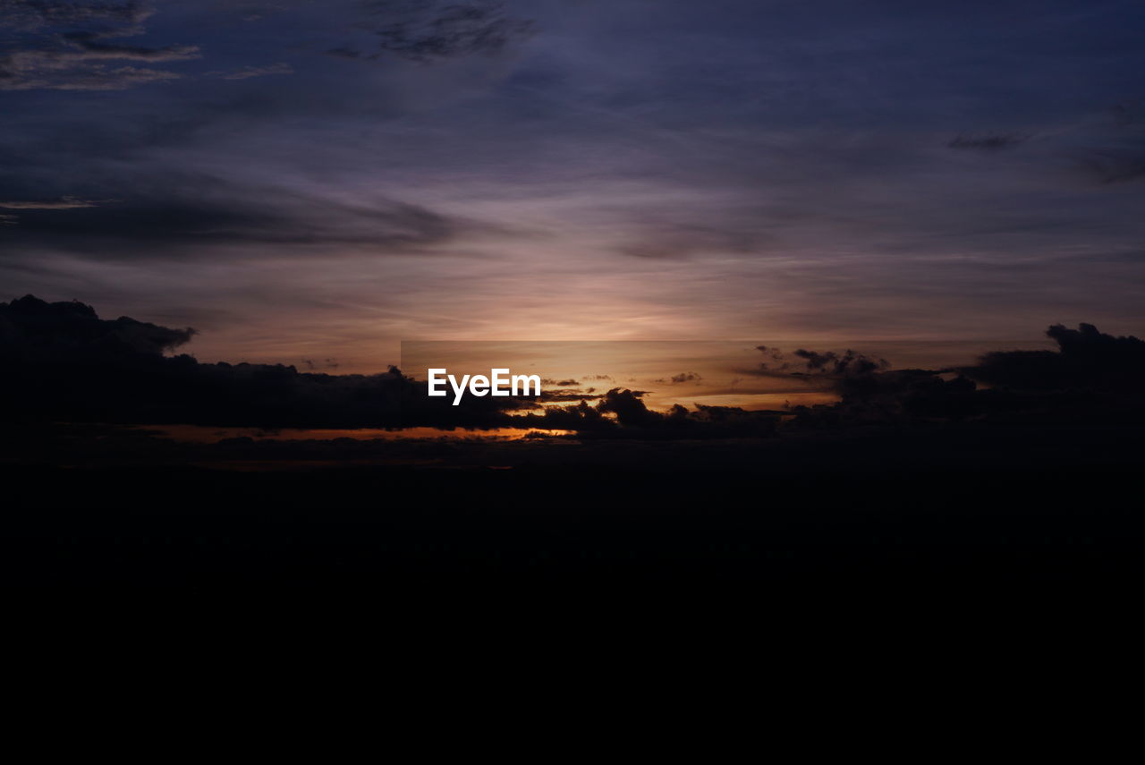 SILHOUETTE LANDSCAPE AGAINST SUNSET SKY