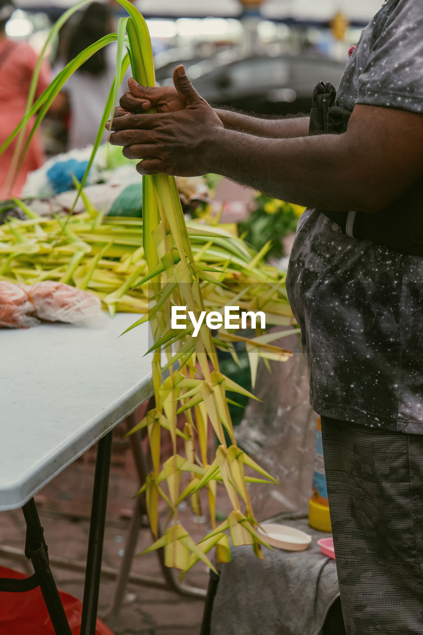Coconut leaves hang for sale in conjuction of deepavali celebration at the market.