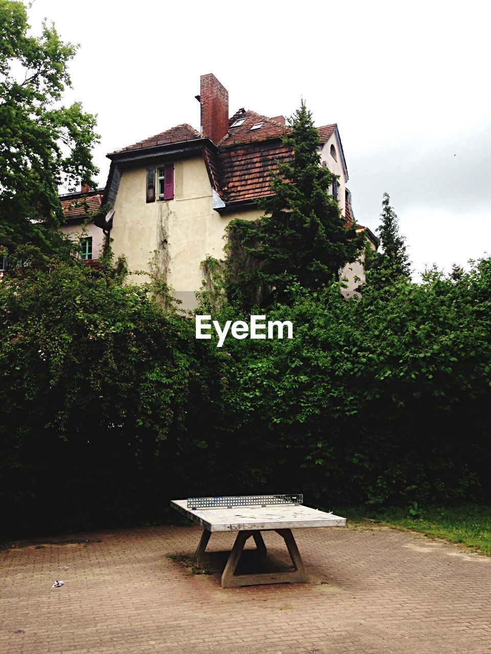 Table in yard in front of houses against sky