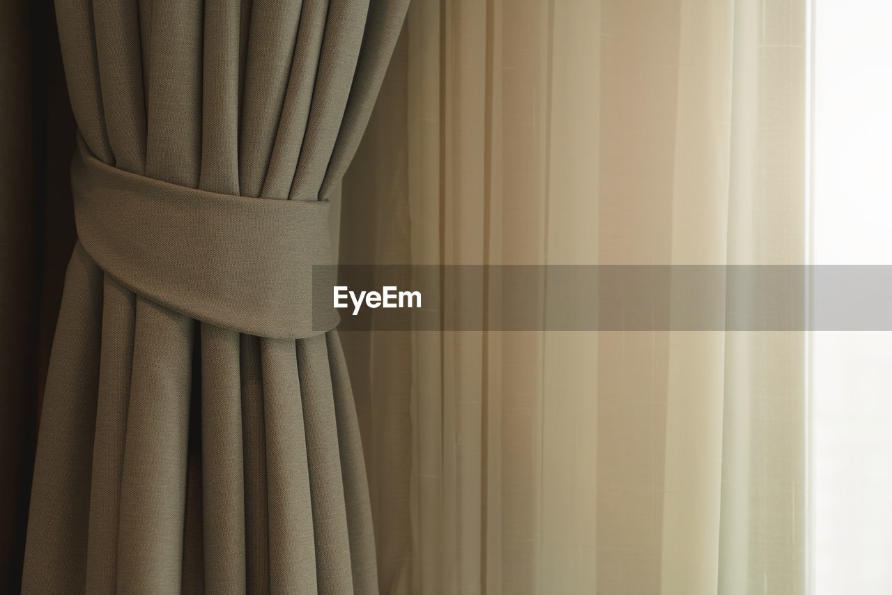 CLOSE-UP OF CURTAIN AGAINST WINDOW