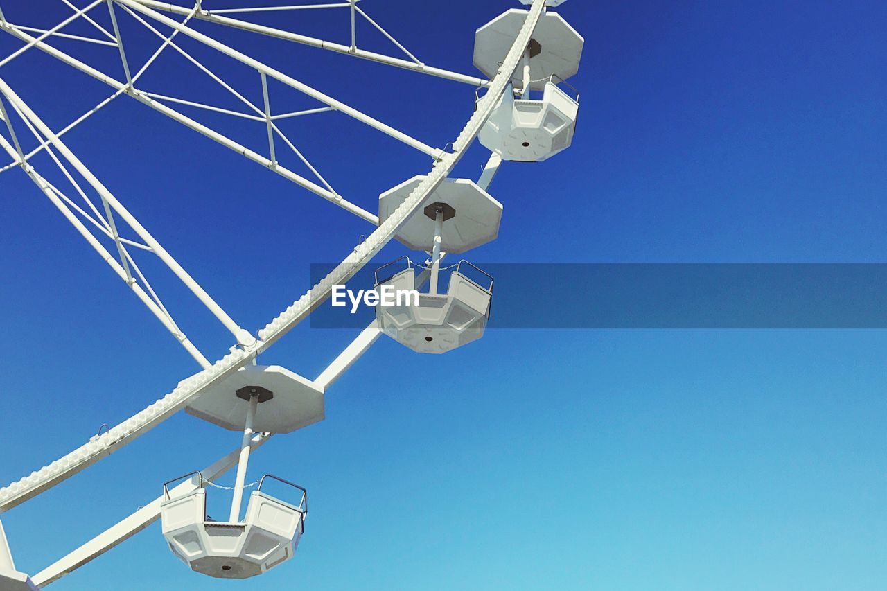 LOW ANGLE VIEW OF COMMUNICATIONS TOWER AGAINST SKY