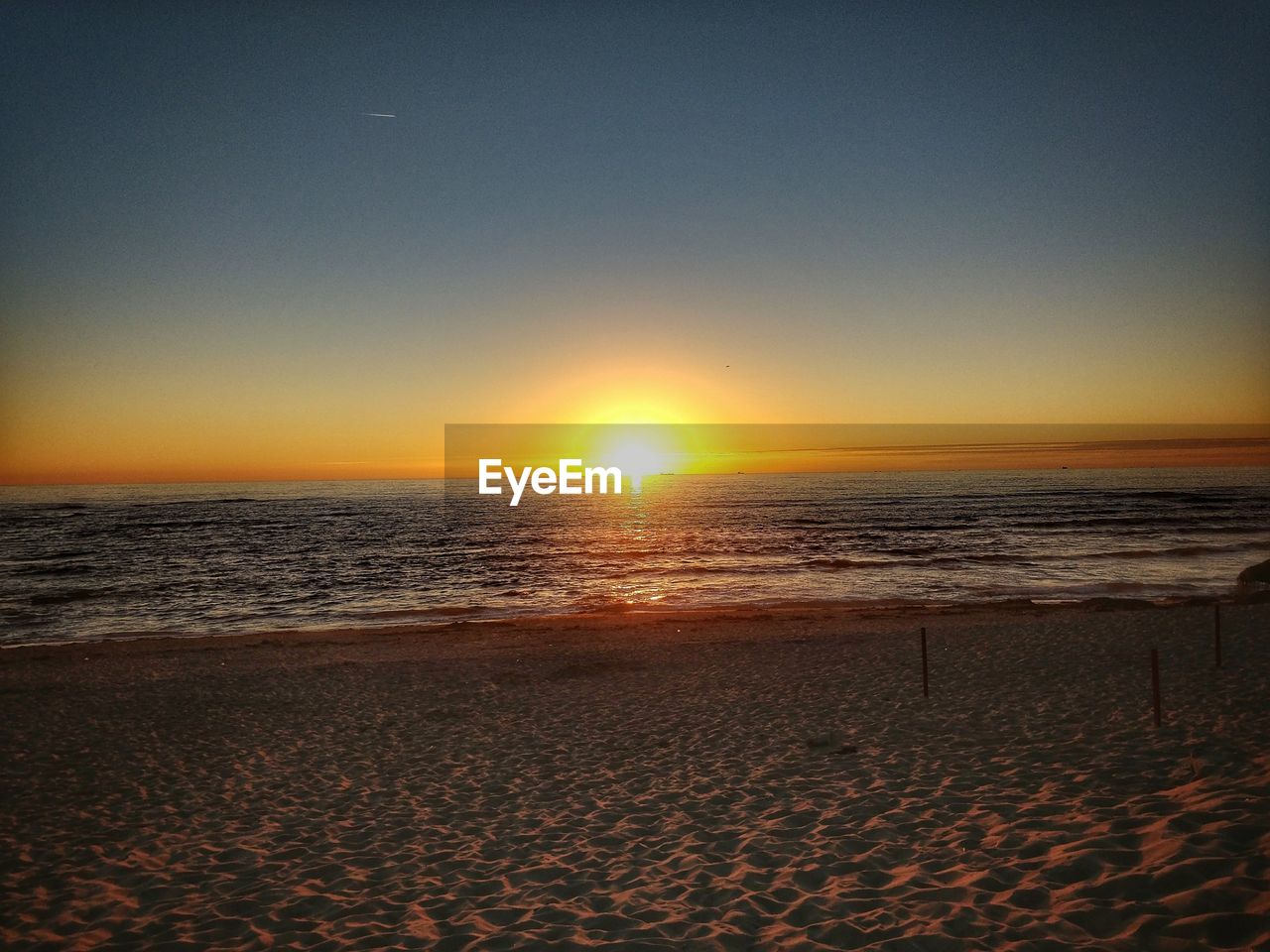 SCENIC VIEW OF BEACH DURING SUNSET