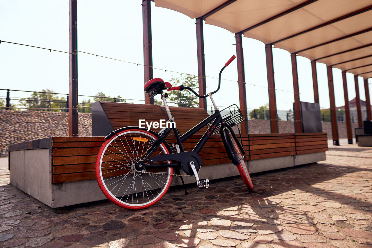 BICYCLE PARKED AGAINST WINDOW