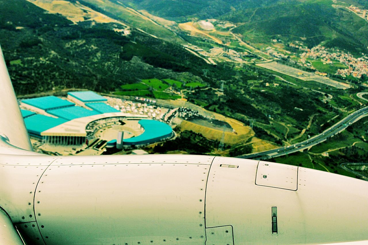 Cropped image of airplane flying over stadium