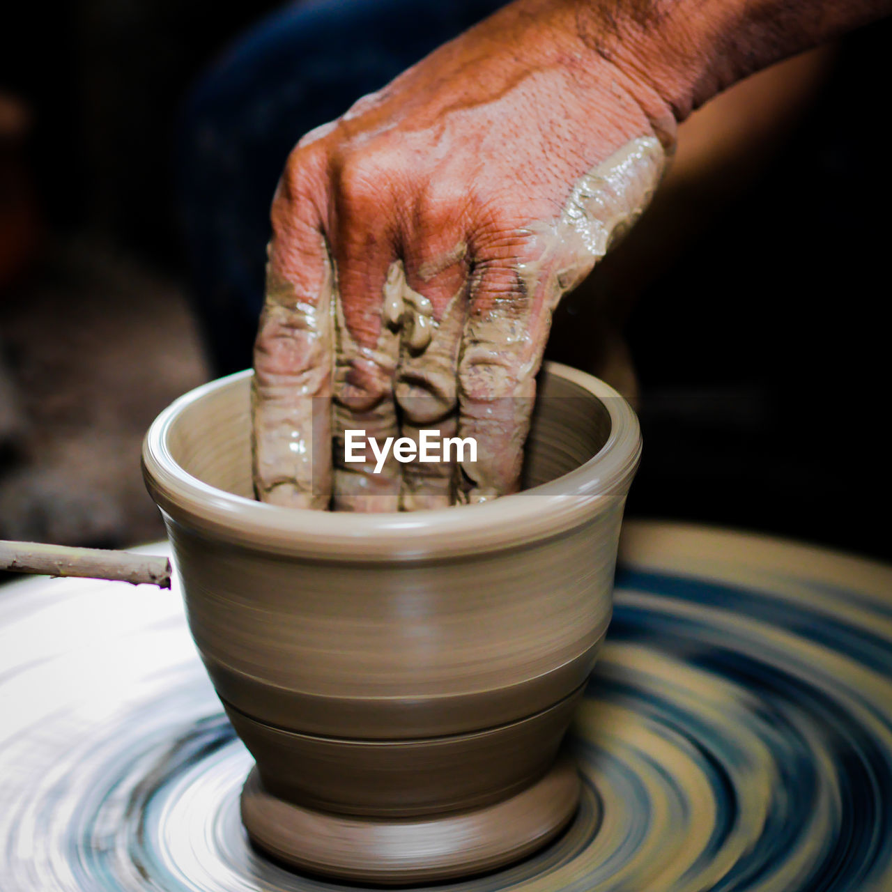 Close-up of person making pot