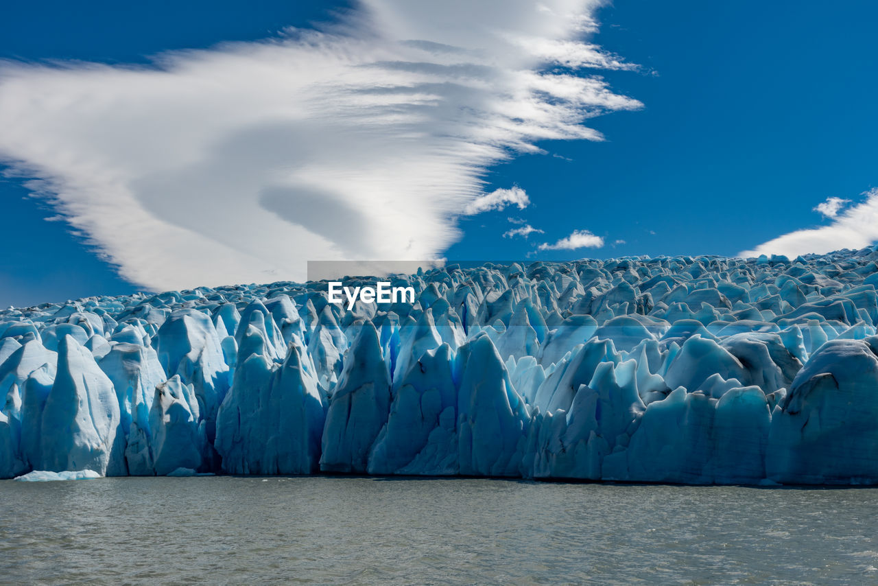 Panoramic shot of frozen lake against sky