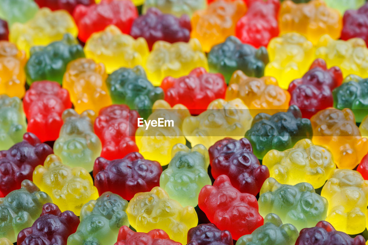 Closeup full-frame background of colorful jelly bears laid closely on flat surface