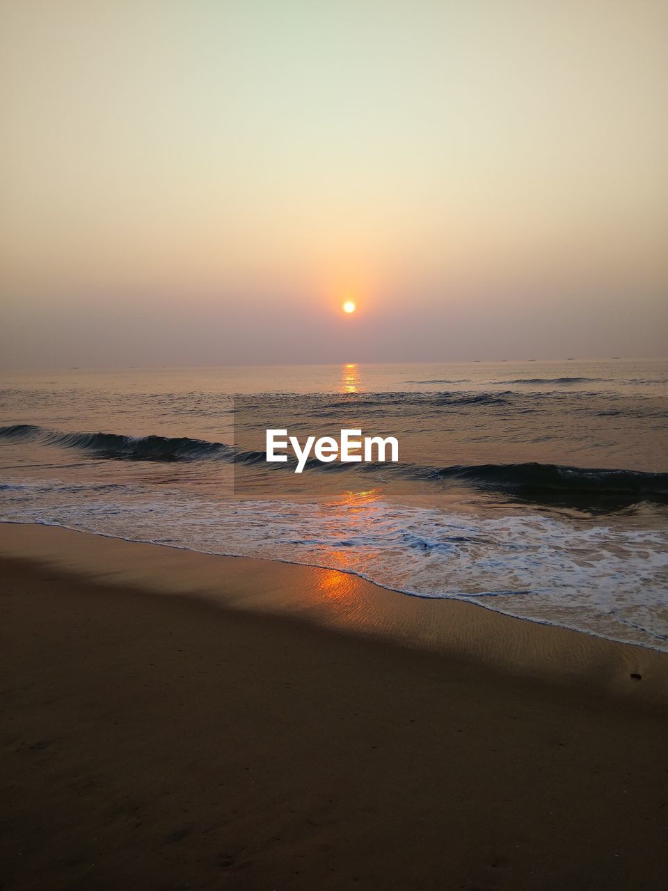 SCENIC VIEW OF BEACH DURING SUNSET