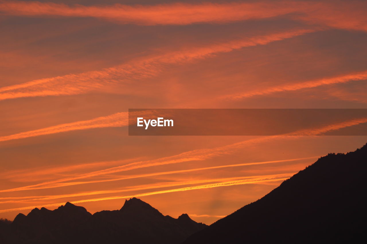 Scenic view of silhouette mountains against sky during sunset