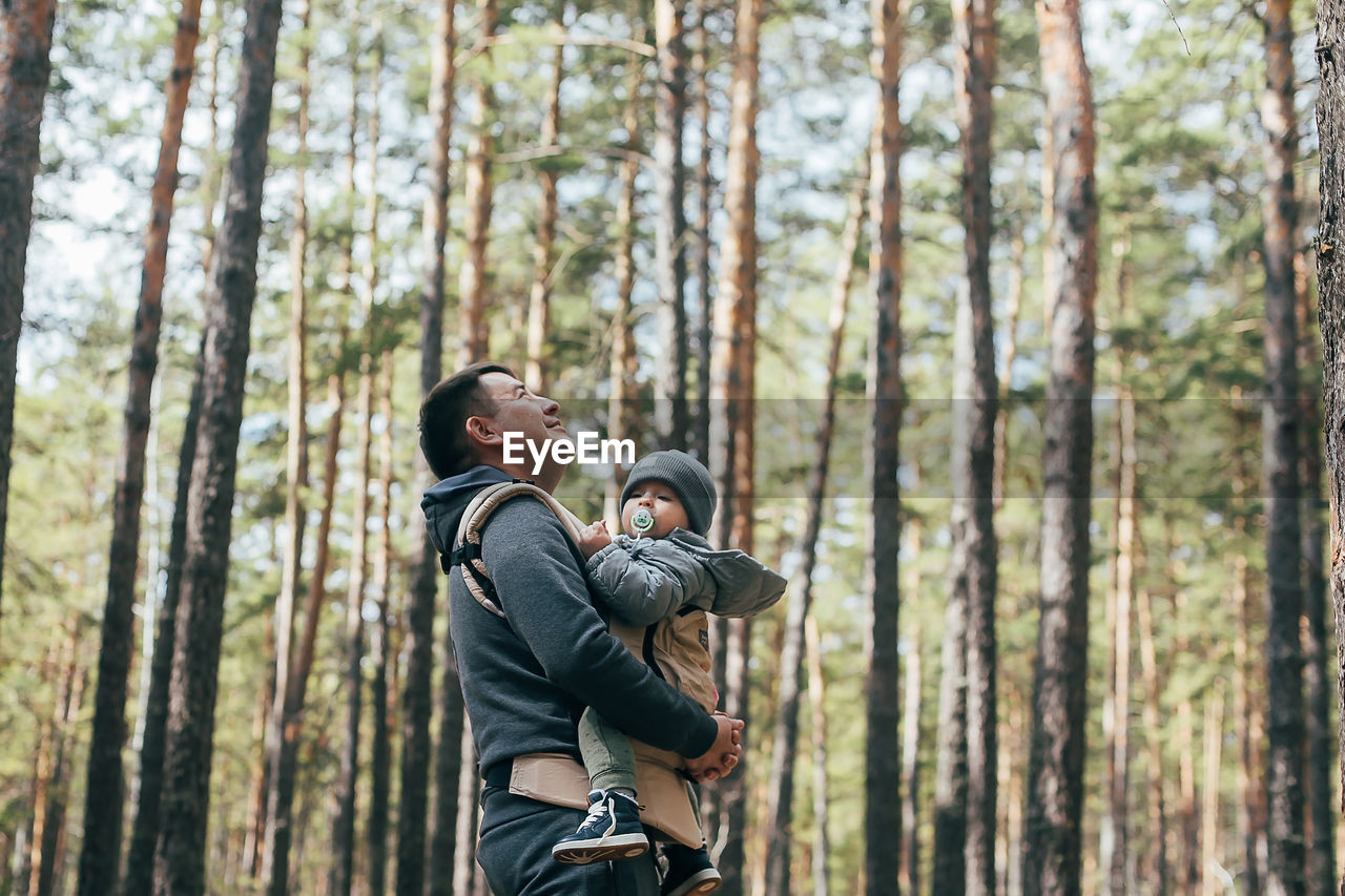 low angle view of woman standing in forest