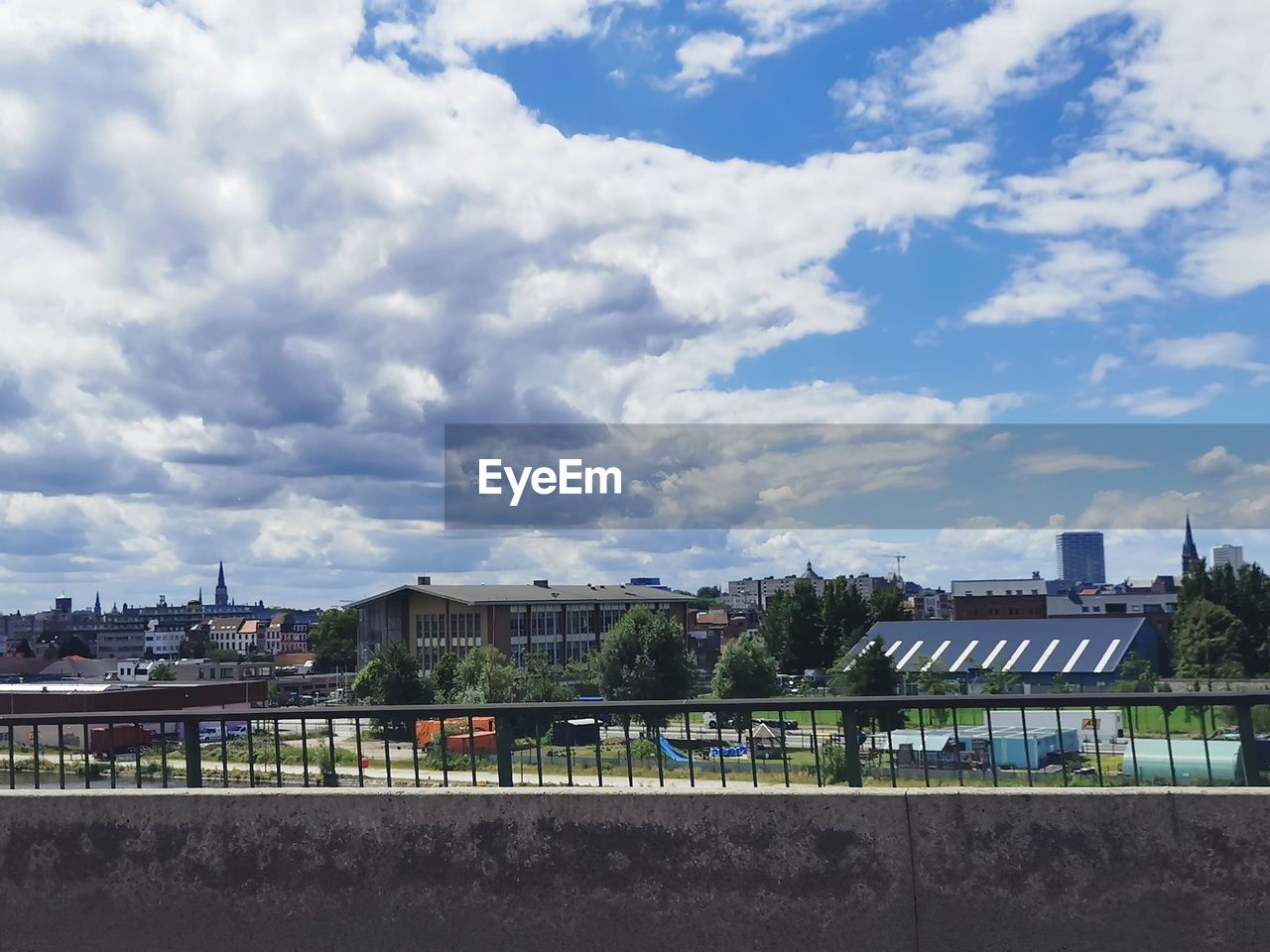 architecture, built structure, cloud, sky, city, building exterior, building, nature, cityscape, urban area, day, horizon, outdoors, no people, skyline, city life, transportation, travel destinations, travel, street, residential district, landscape, road, tree