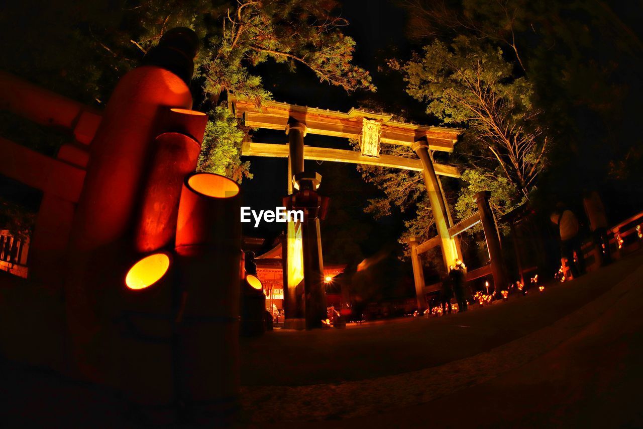 ILLUMINATED LANTERNS ON BUILDING AT NIGHT