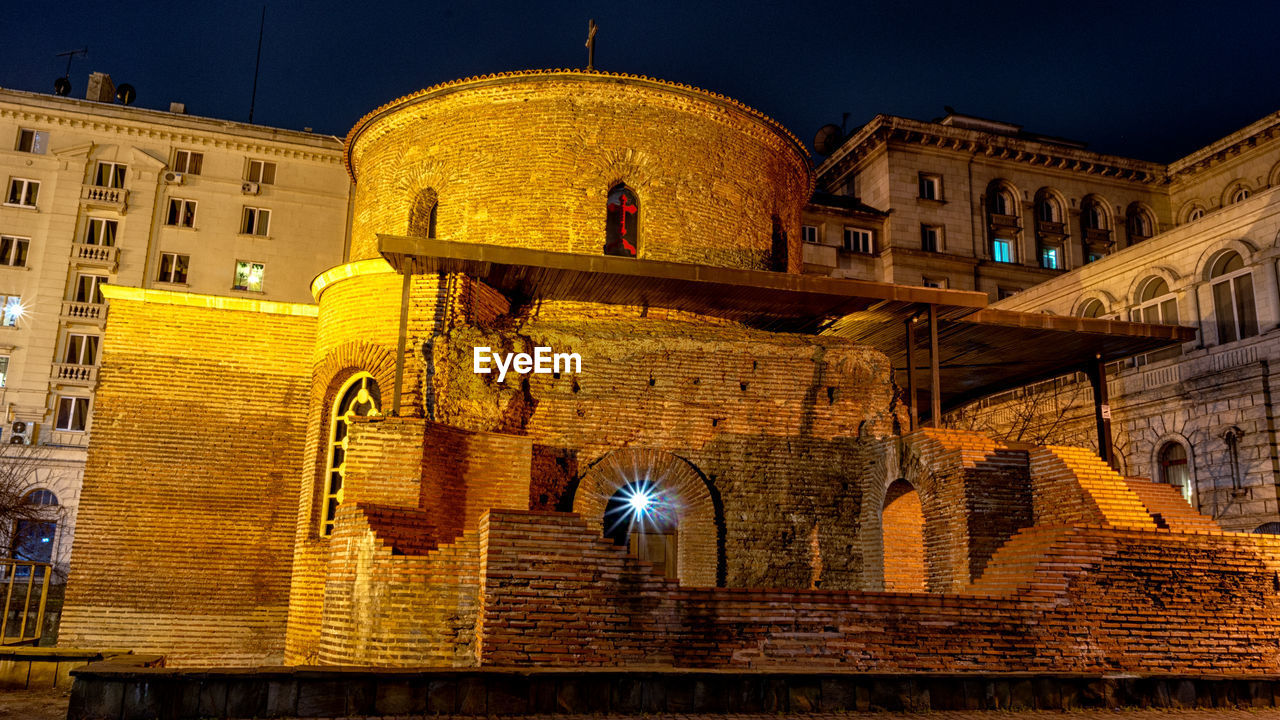 LOW ANGLE VIEW OF ILLUMINATED BUILDING