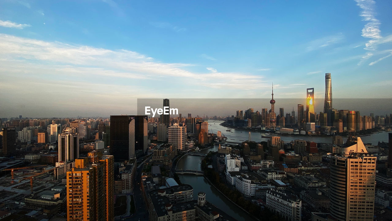 Aerial view of modern buildings in city against sky