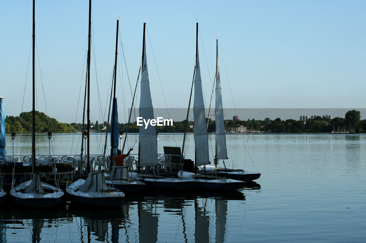 SAILBOATS MOORED IN MARINA