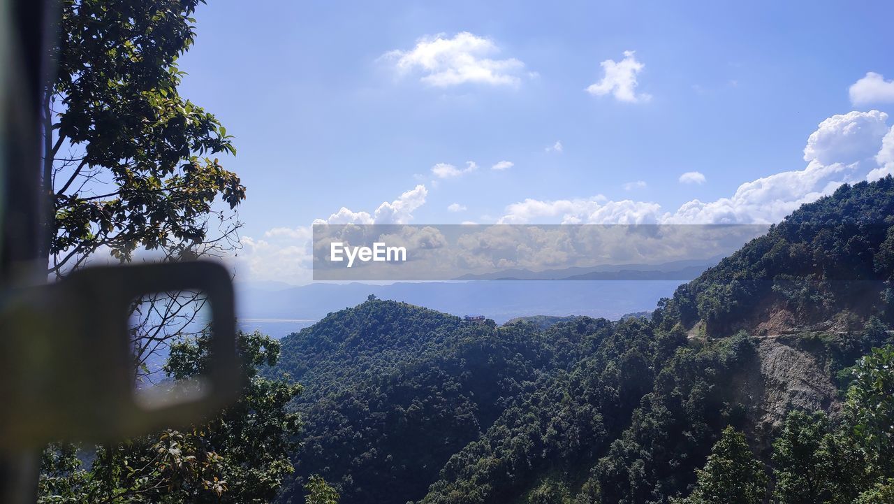 sky, nature, mountain, tree, cloud, scenics - nature, plant, environment, beauty in nature, landscape, land, mountain range, forest, tranquility, travel, outdoors, pinaceae, no people, tranquil scene, day, travel destinations, wilderness, pine tree, blue, coniferous tree, tourism, non-urban scene, sunlight, idyllic, panoramic