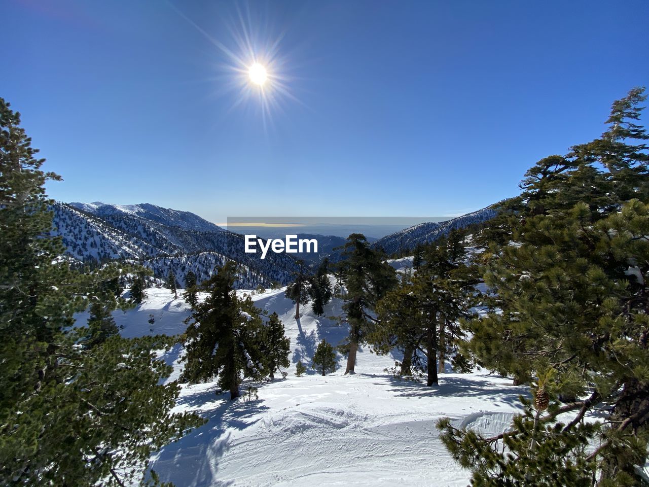 Scenic view of snowcapped mountains against clear sky