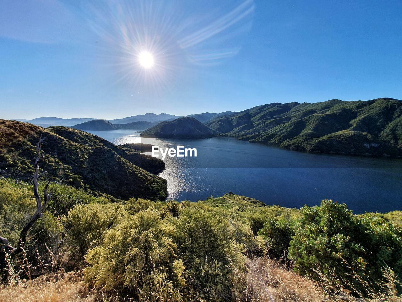 Scenic view of mountains against bright sun